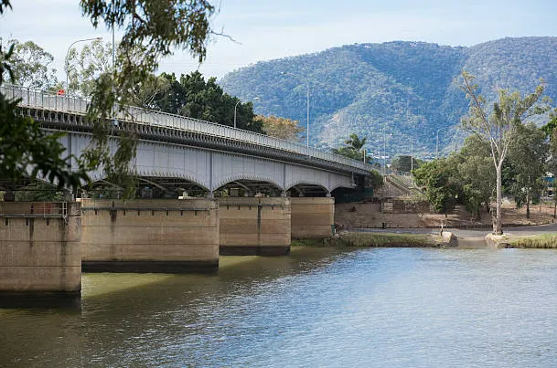 Concrete Bridge Over a River With Mountains in the Background — SSP Insurance In Rockhampton, QLD