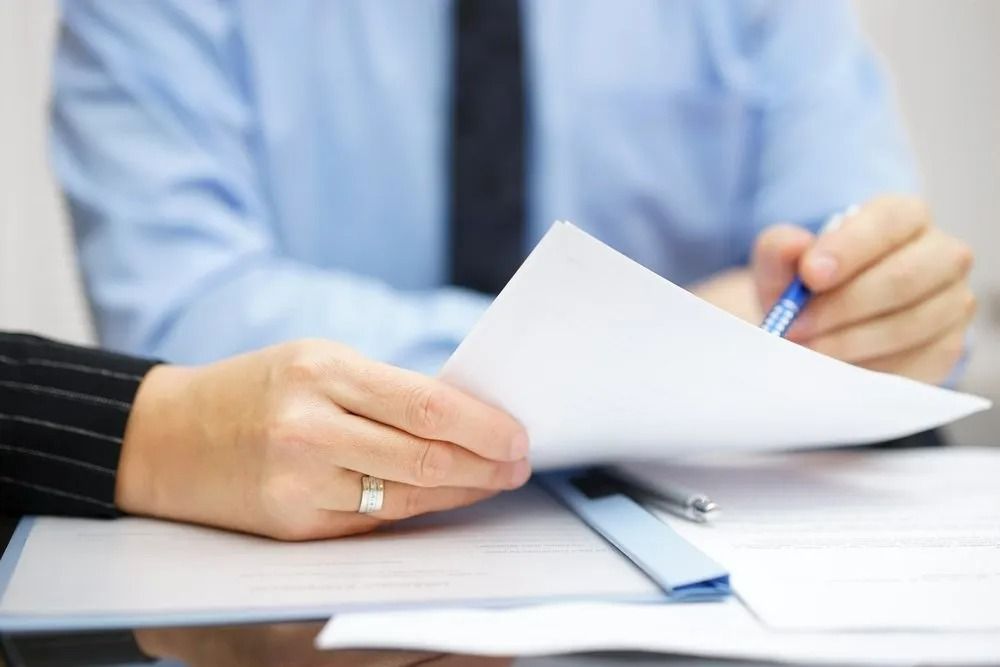 Hands Holding and Reviewing Document — SSP Insurance In Rockhampton City, QLD