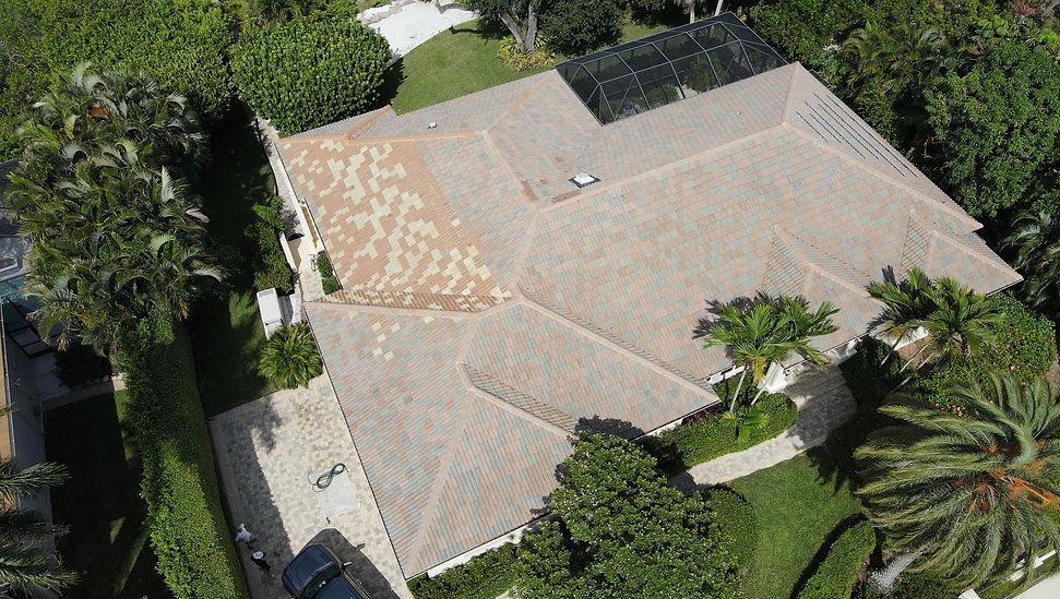 An aerial view of a house with solar panels on the roof.