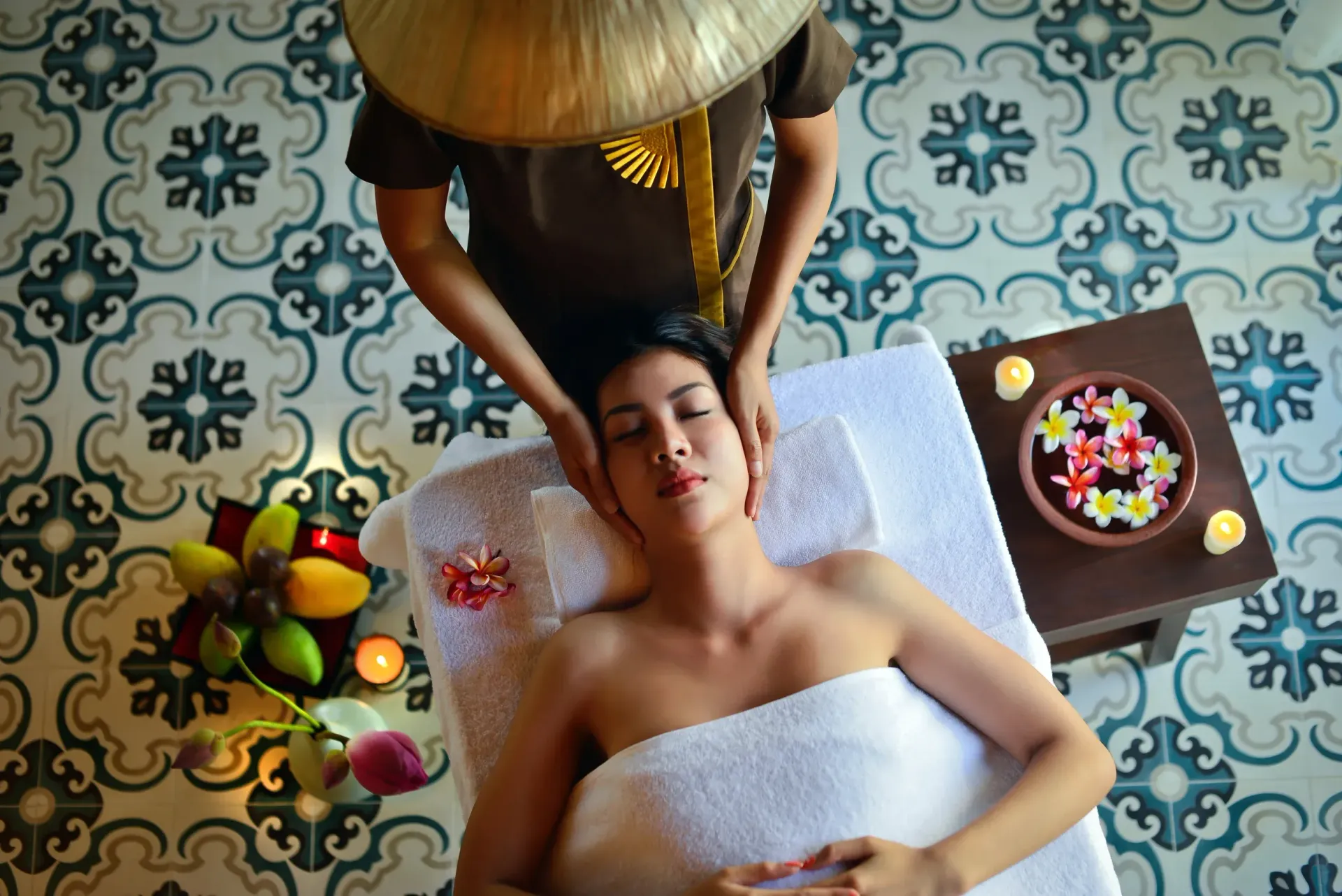 A woman is getting a head massage at a spa.
