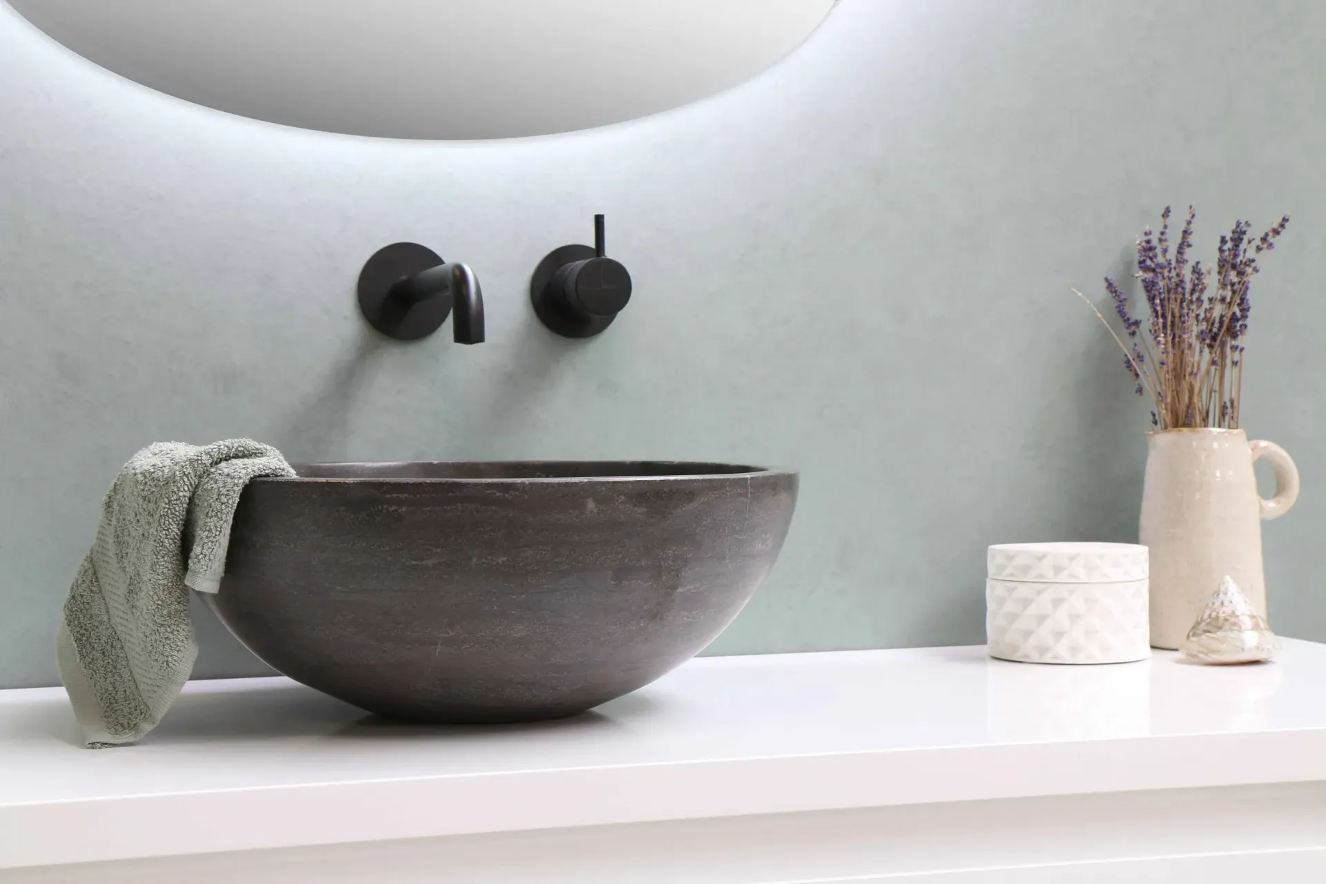 A bathroom sink with a towel hanging out of it and a mirror.