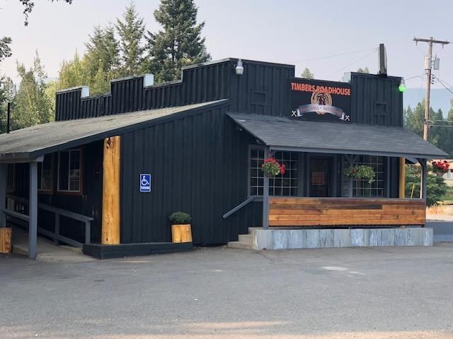 Black building with ramp and sign
