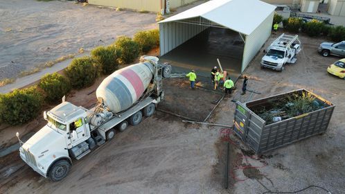 An aerial view of a concrete mixer truck in a parking lot.