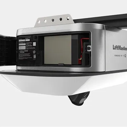 A silver LiftMaster garage door opener with an open battery compartment and a downward-facing camera lens.