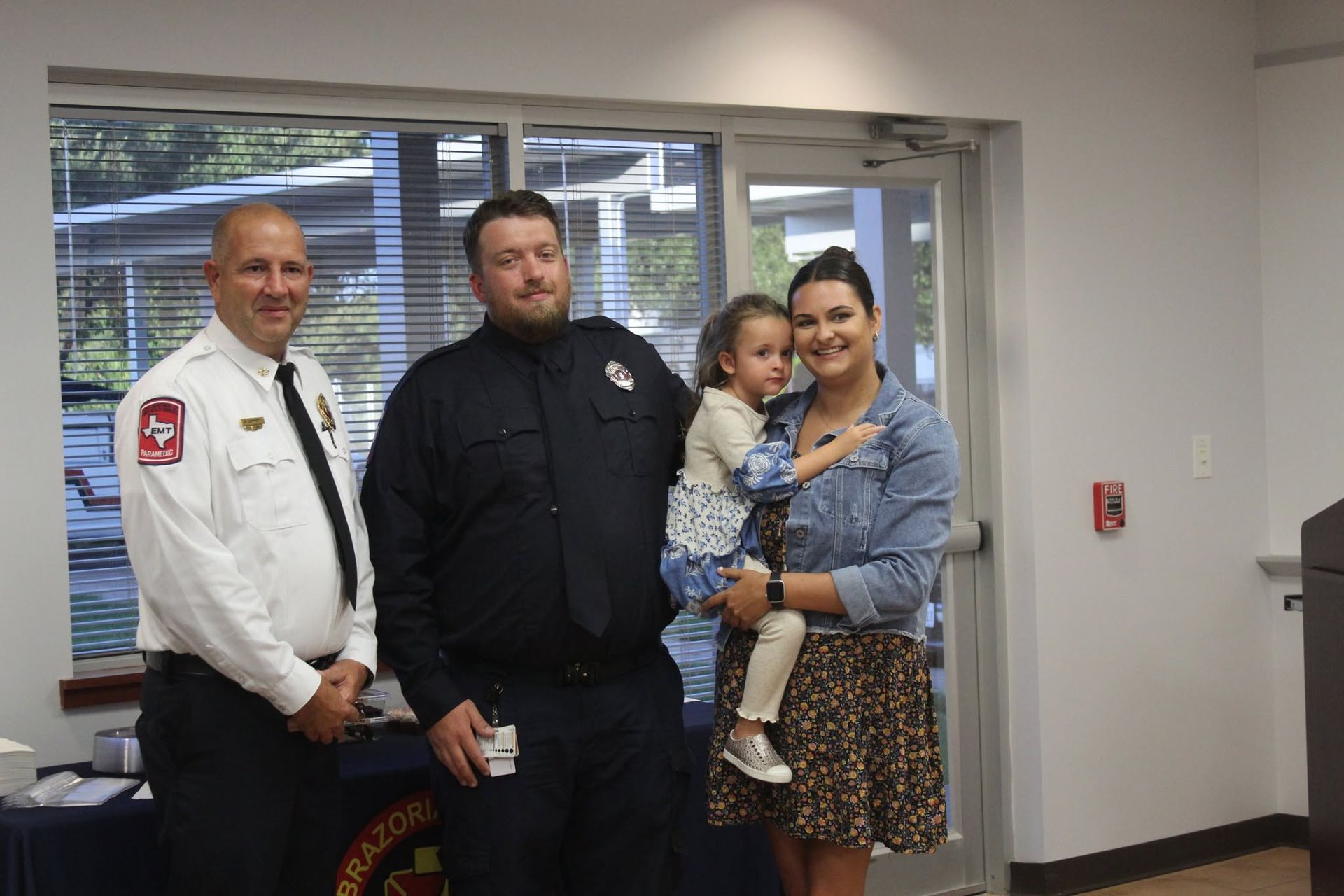 Three adults and a child posing for a picture after swearing in ceremony.