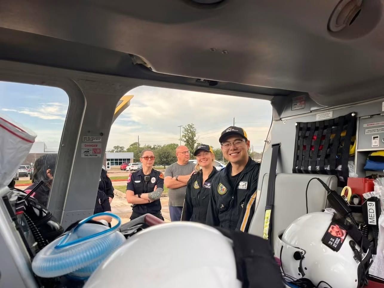 Four emergency responders looking through a medical helicopter.