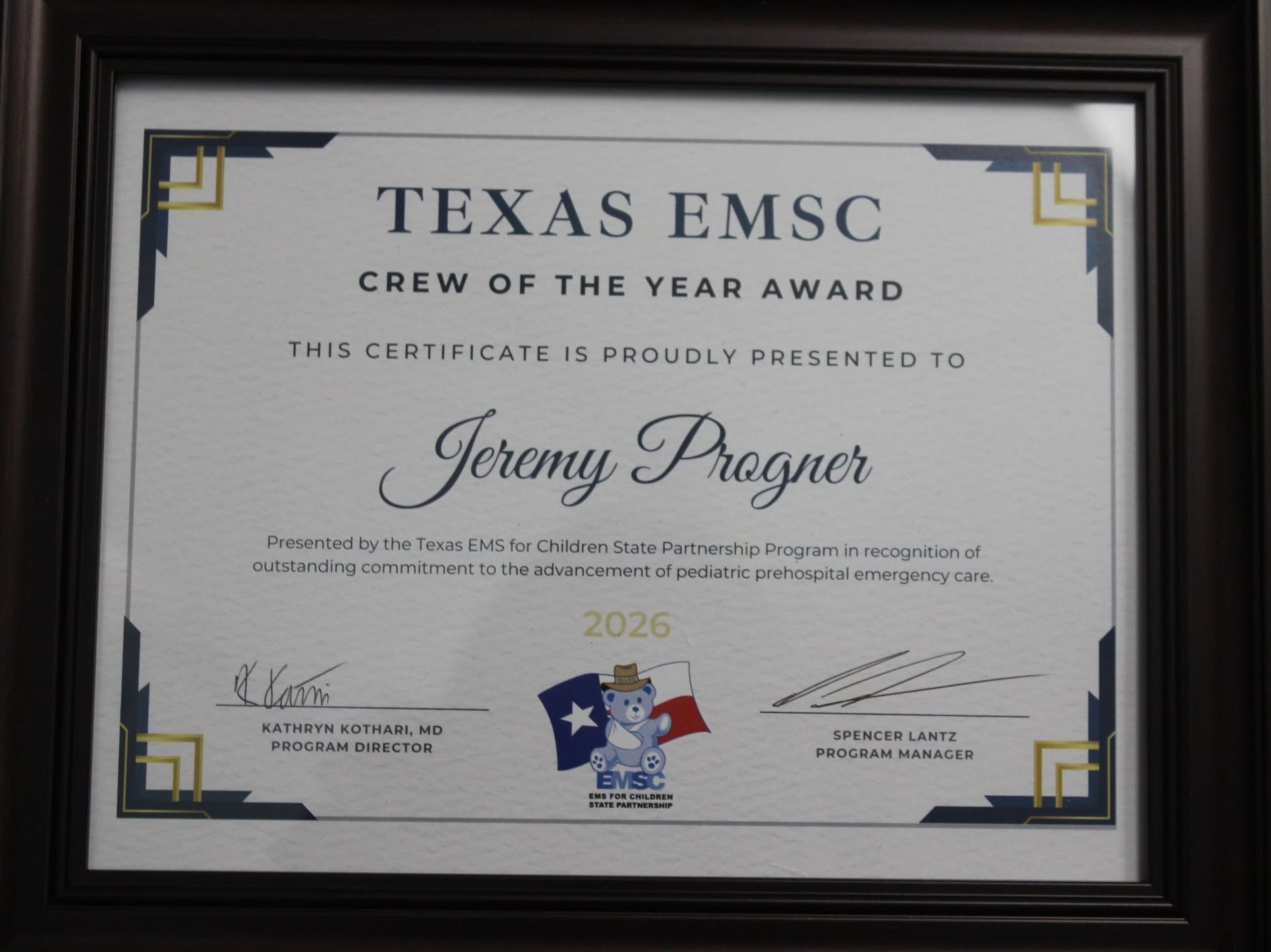 Texas EMSC Crew of the Year award certificate in a black frame with navy and gold accents