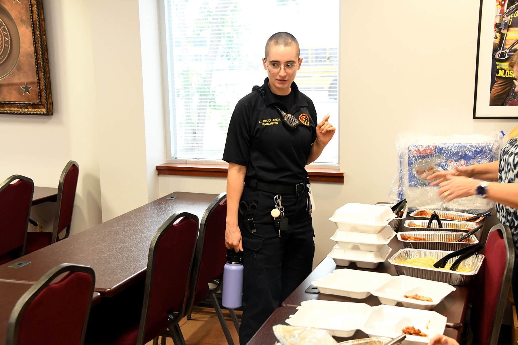 Paramedic standing beside a buffet table in a dining room