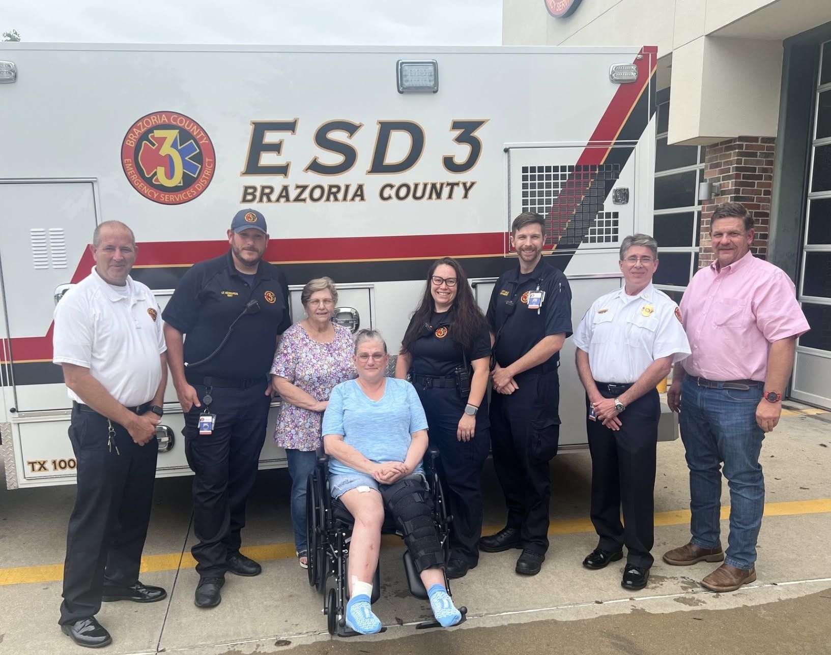 Group posed in front of an ESD3 Brazoria County emergency vehicle, with one person seated in front.