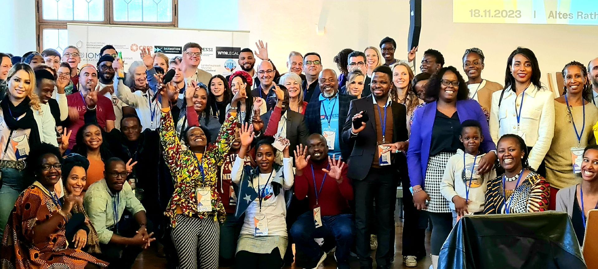 A large group of people are posing for a picture in a room.