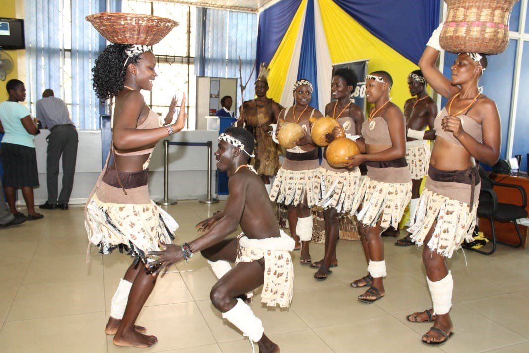 A group of people are dancing with baskets on their heads