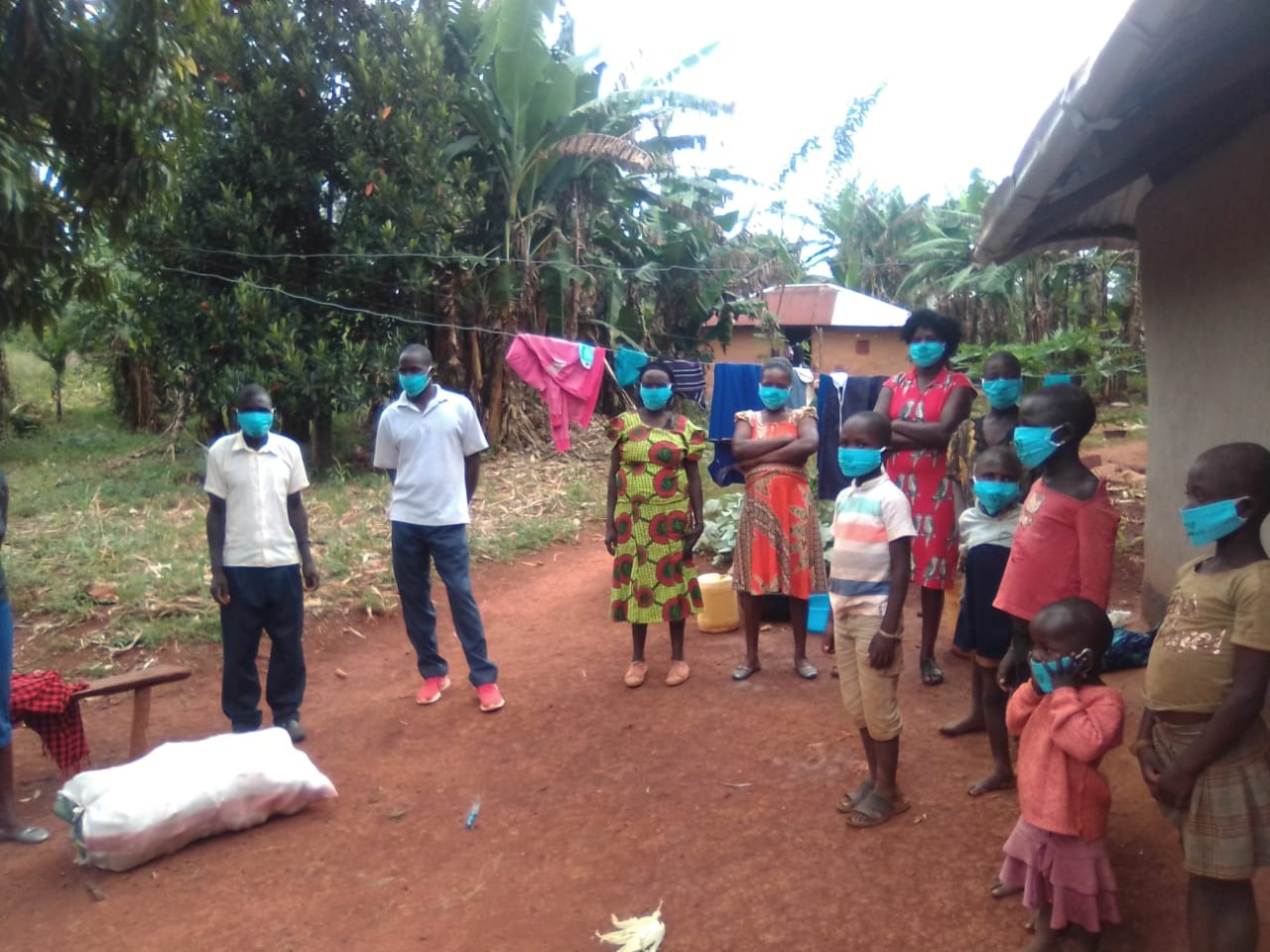 A group of people wearing face masks standing outside