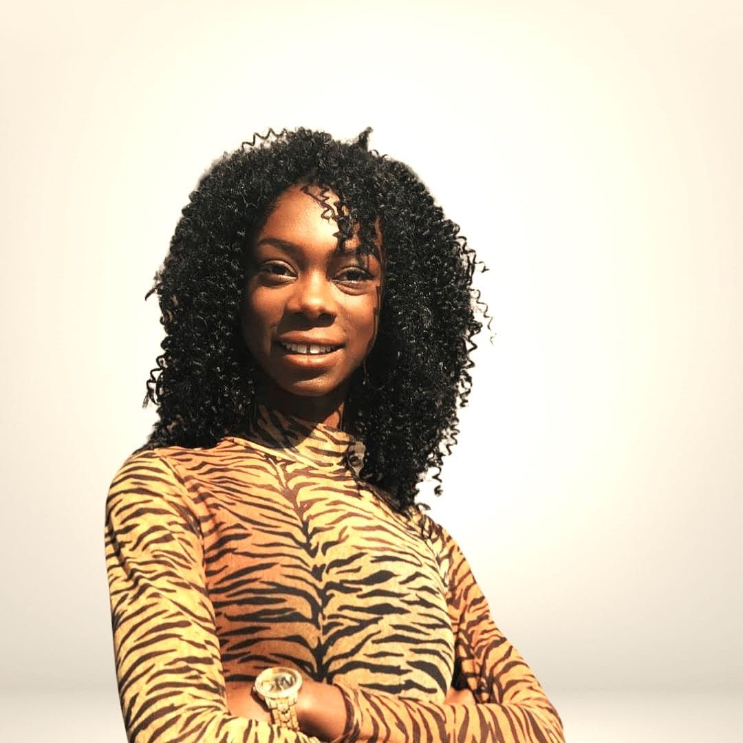 A woman with curly hair is wearing a tiger print shirt
