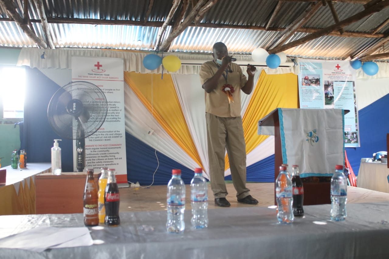 A man stands on a stage with a microphone in his hand