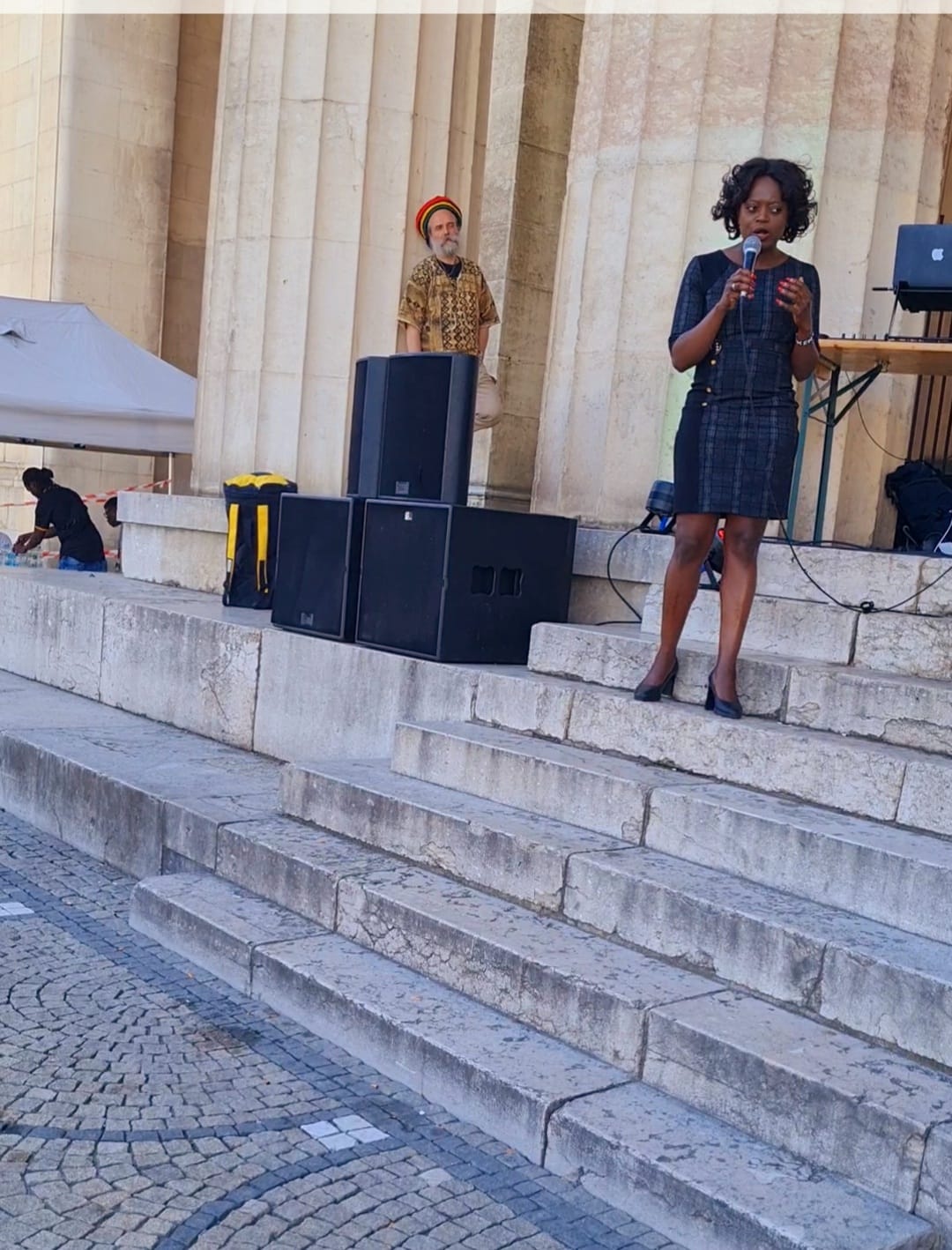 A woman is standing on a set of stairs holding a microphone
