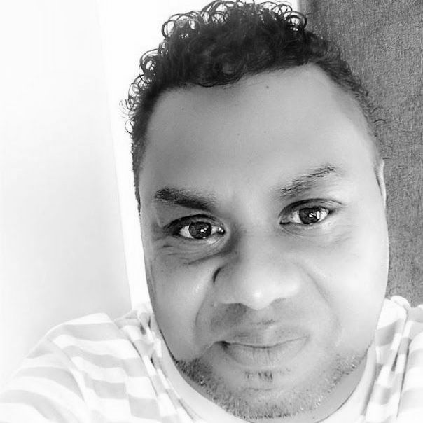 a man with curly hair is taking a selfie in a black and white photo . Jean LALOYER Commercial Leadspotion NC