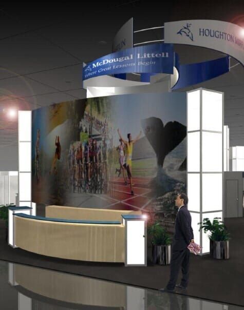 Trade show booth featuring a large photo display, reception desk, and a man standing nearby.