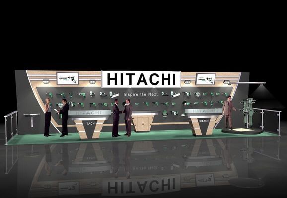 Hitachi trade show booth with products displayed, people interacting, and reflective floor.
