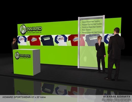 Trade show booth with green backdrop, Howard Sportswear logo, and t-shirts on display; people standing.