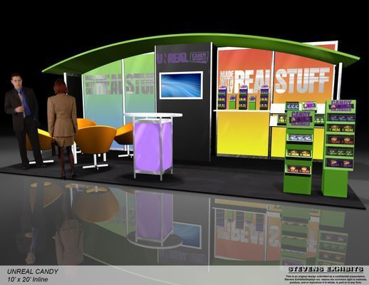 Trade show booth with green and orange accents, featuring display shelves, a monitor, and two people.