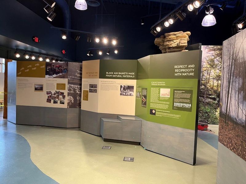 Museum exhibit with informational panels and photographs.
