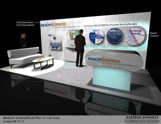Trade show booth for BrachySciences with a man viewing the display, featuring a sofa, desk, and product visuals.