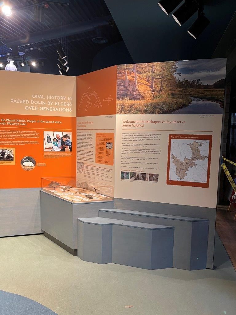 Museum exhibit with informational panels, a diorama, and steps.