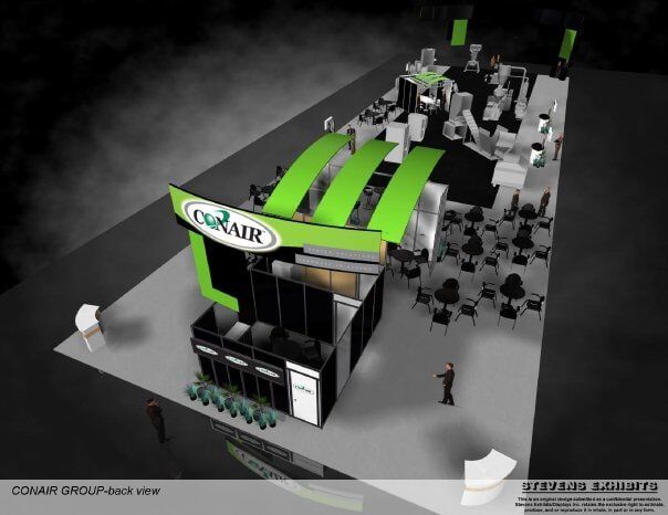 Conair trade show booth with green accents and logo. Includes seating area, displays, and staff.