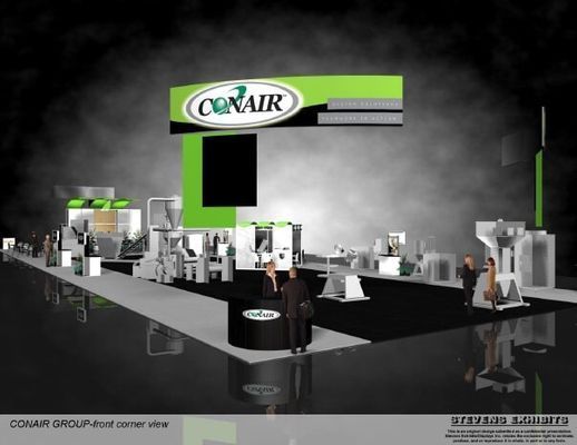 Conair Group trade show booth with machinery, bright green accents, and people.