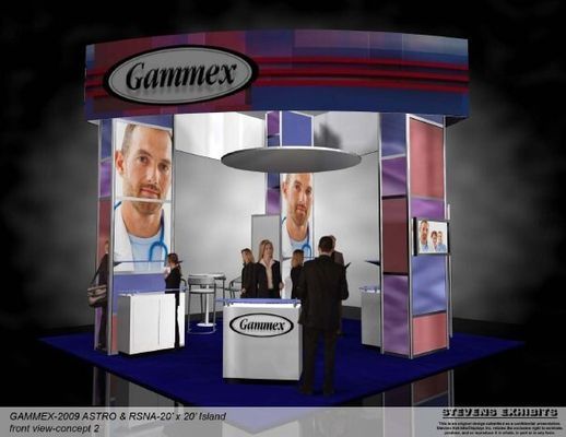 Gammax trade show booth with doctor image, logo, and people. Blue, silver, and purple colors.