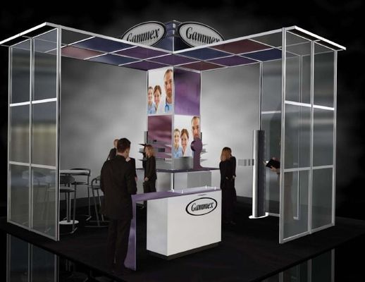 Trade show booth with people, display, and company logo.