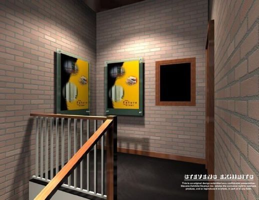Stairwell with brick walls, posters, and a blank frame. Yellow and black posters with circular designs.