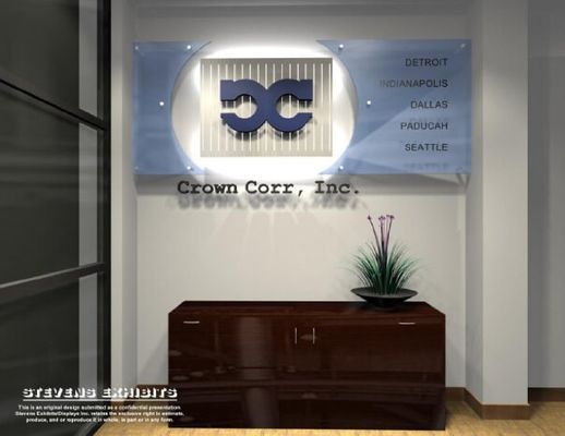 Reception area with Crown Corr, Inc. sign. Blue logo, office locations listed, dark wooden cabinet with potted plant.