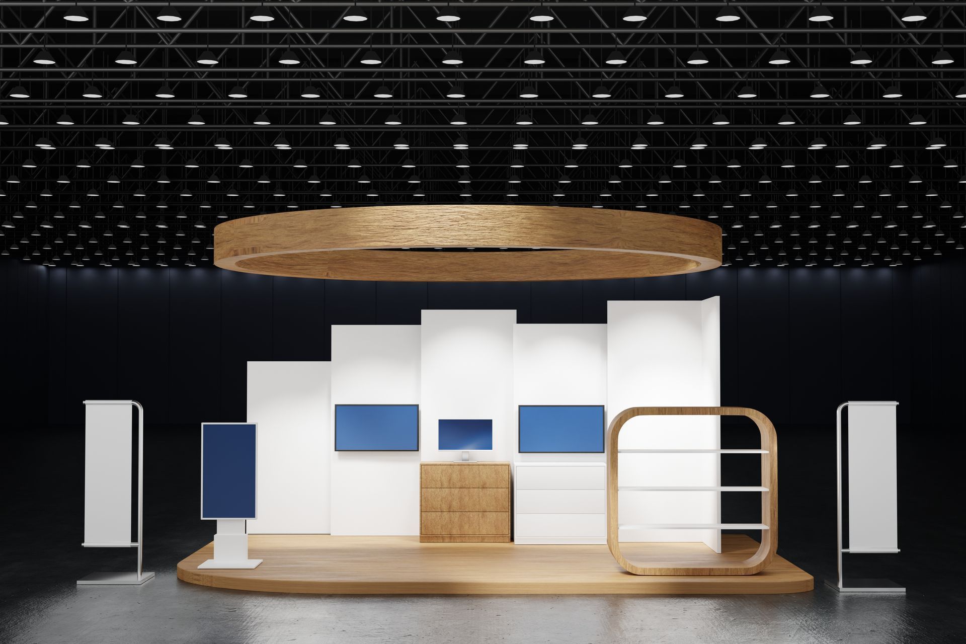Empty exhibition booth with white walls, blue panels, wooden podium, and circular overhead display on a dark stage