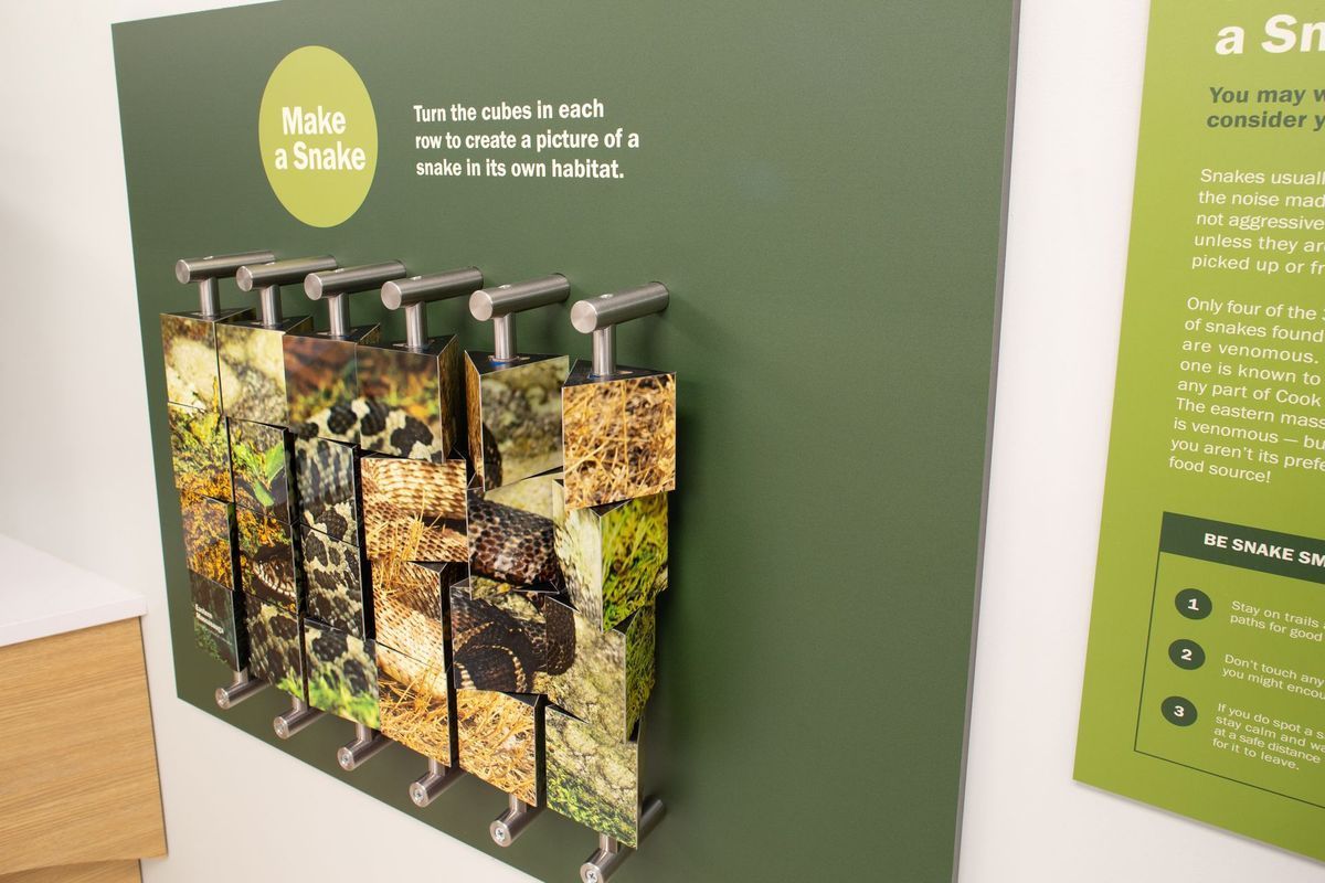 Interactive exhibit: blocks with textured images on a green background.