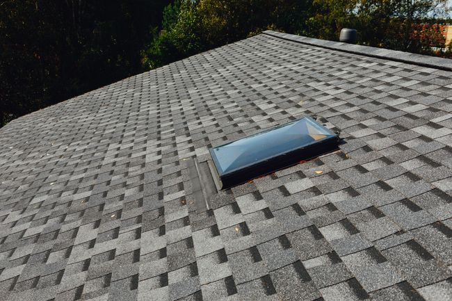 Gray asphalt shingle roof with a rectangular skylight.