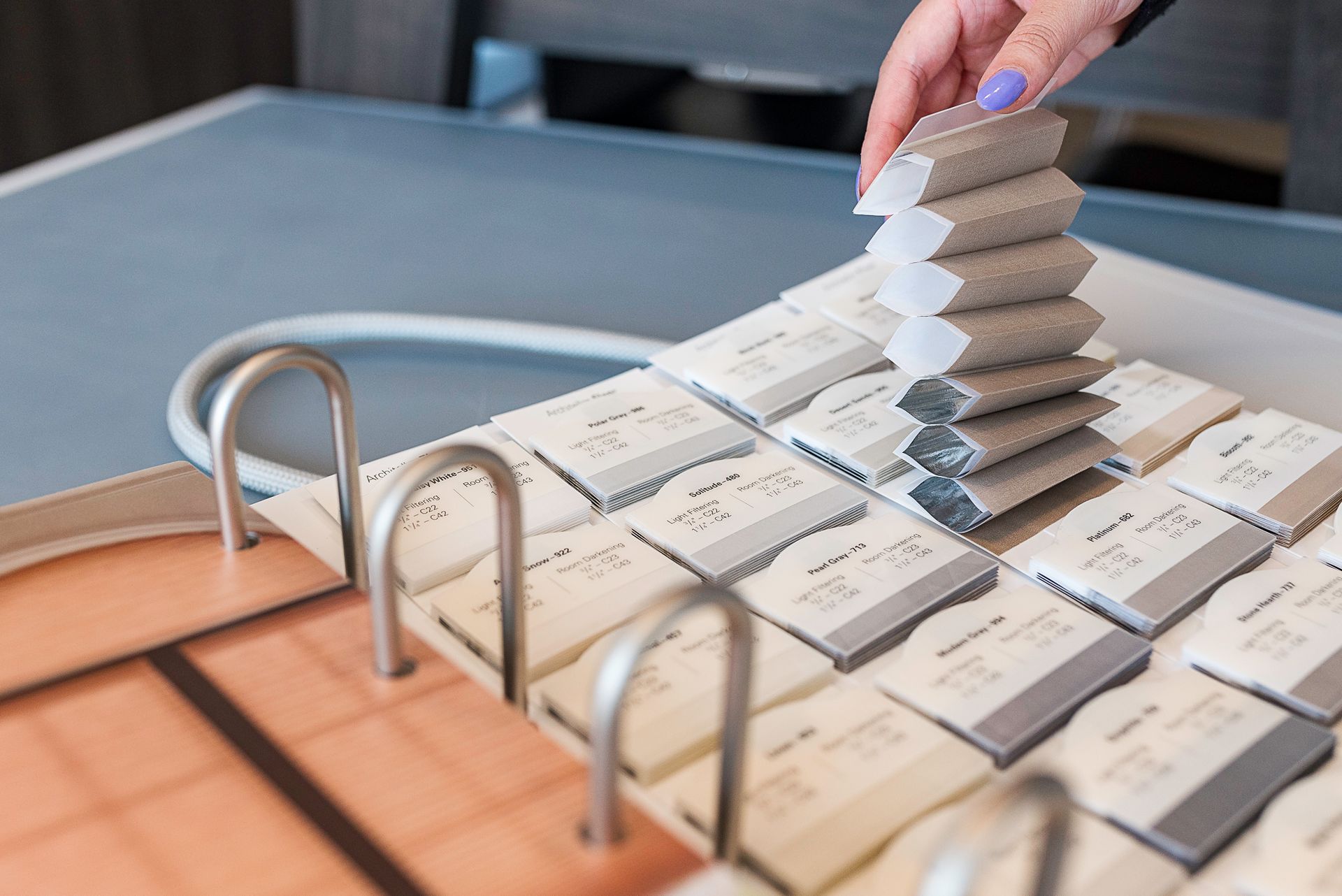 Hand placing a stack of white cards on a binder of labeled cards