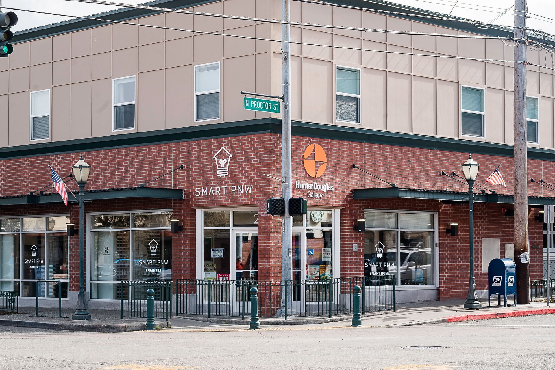 Corner street café with red brick facade and outdoor seating on a city intersection.
