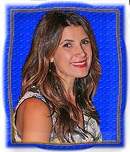 A woman with long hair is smiling in a blue frame.