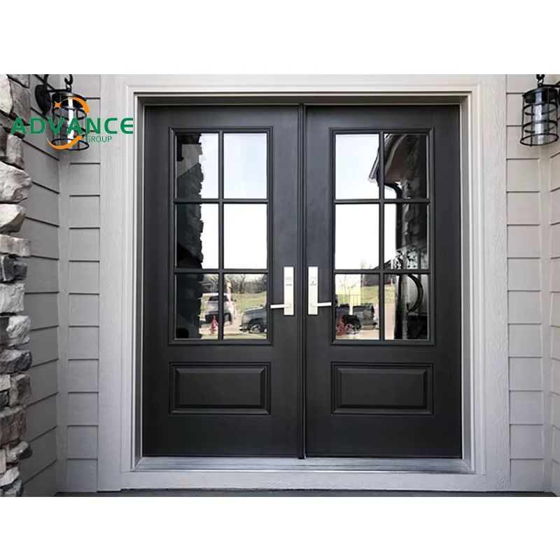 Black double doors with glass panes, silver handles, and white trim on gray siding. Black double doors with glass panes, silver handles, and white trim on gray siding.