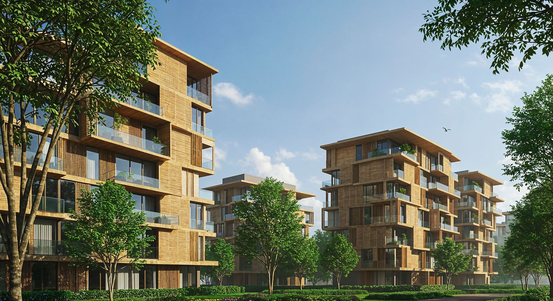 Modern apartment buildings with balconies in a green, tree-lined residential complex under a blue sky