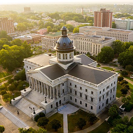 Aerial view of the South Carolina State House in Columbia, a large white building with a dome