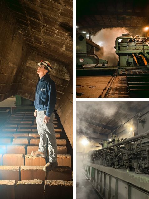Worker standing on industrial stairs inside a dim, dusty factory with heavy machinery nearby