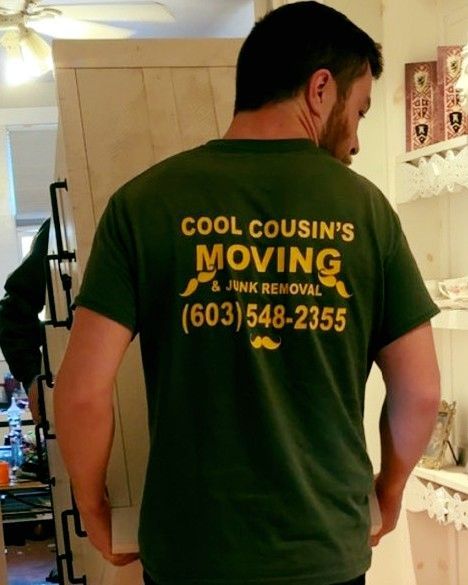 Man wearing green “Cool Cousin’s Moving” T-shirt with yellow text and phone number on the back