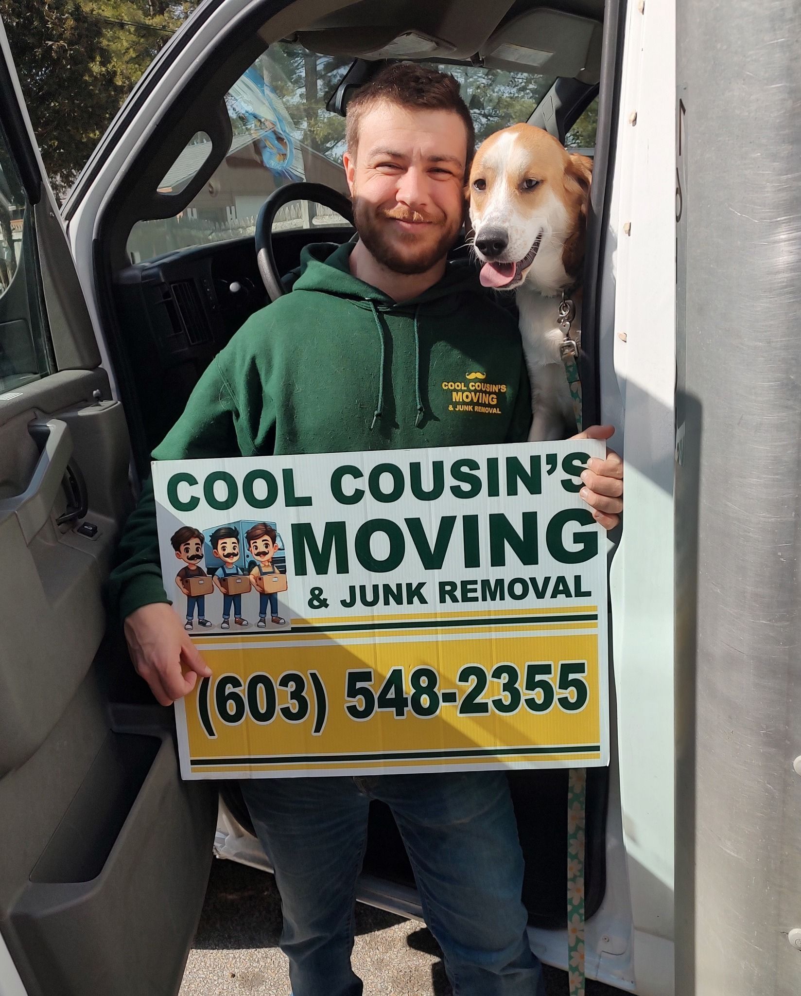Man holding a Cool Cousin’s Moving sign with a dog in a van doorway, phone number visible