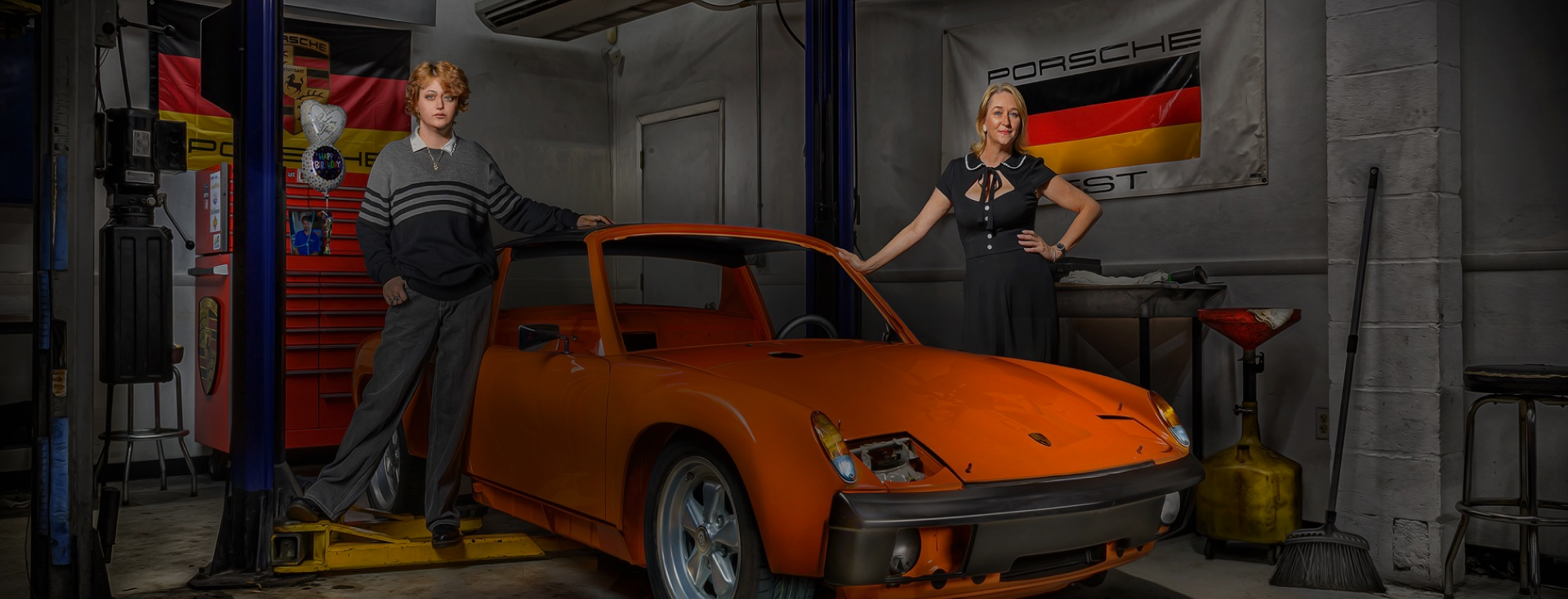 Two women posed by orange Porsche image from Ray Baldino Automotive Luxury Car Photography | German Excellence