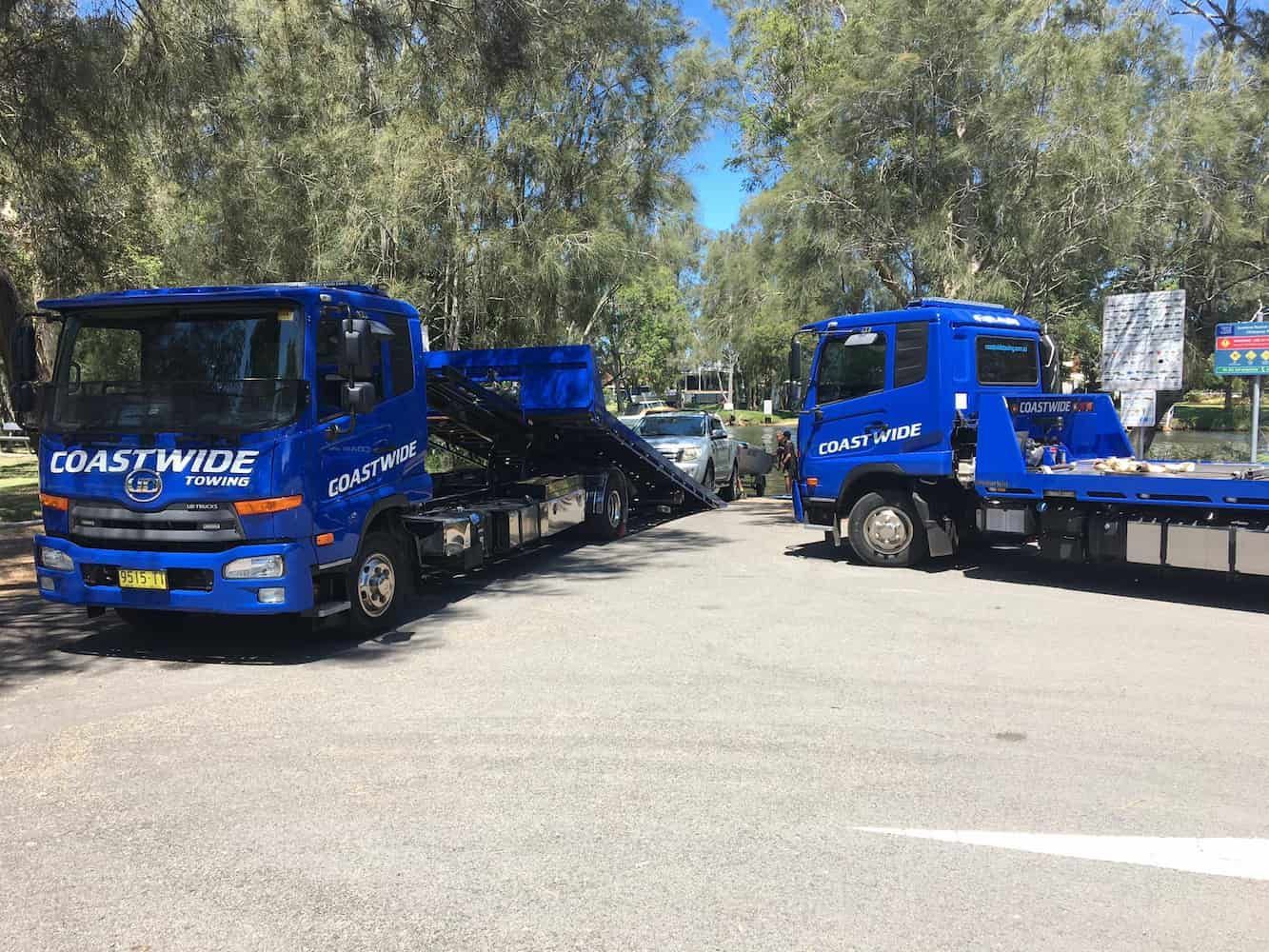A Flatbed Truck Towing A Car