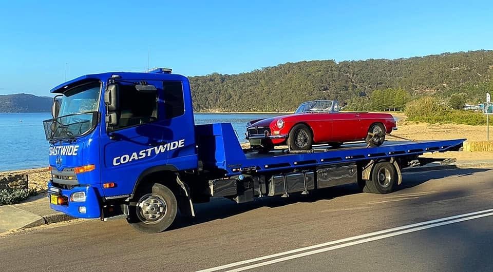 Blue Coastwide Tow Truck Carries Car in Newcastle
