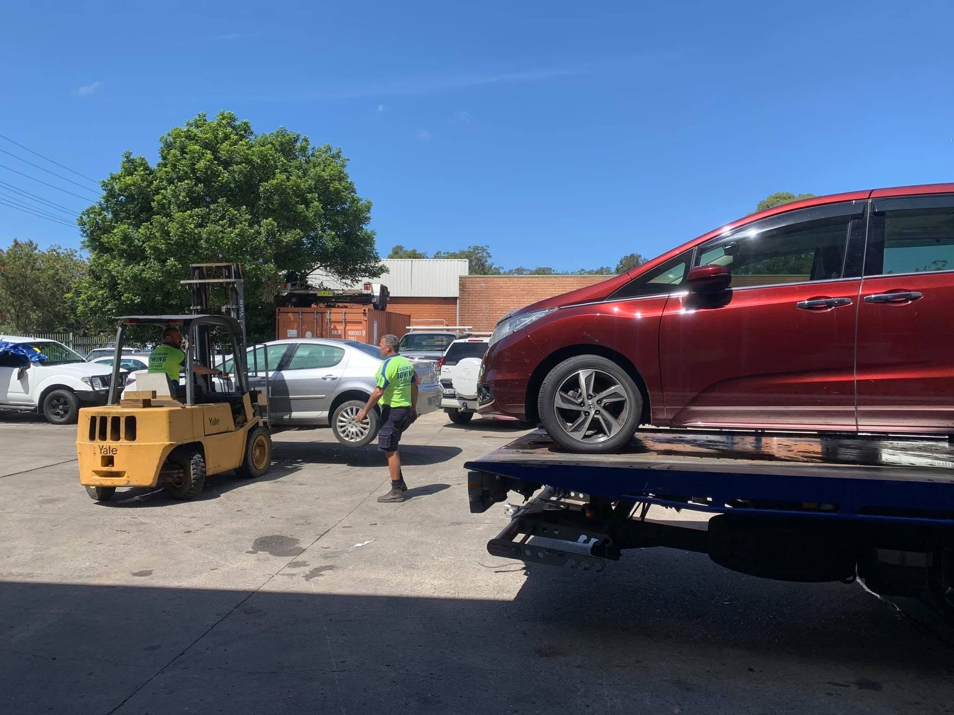 Red Mini Van on Tow Truck in Newcastle