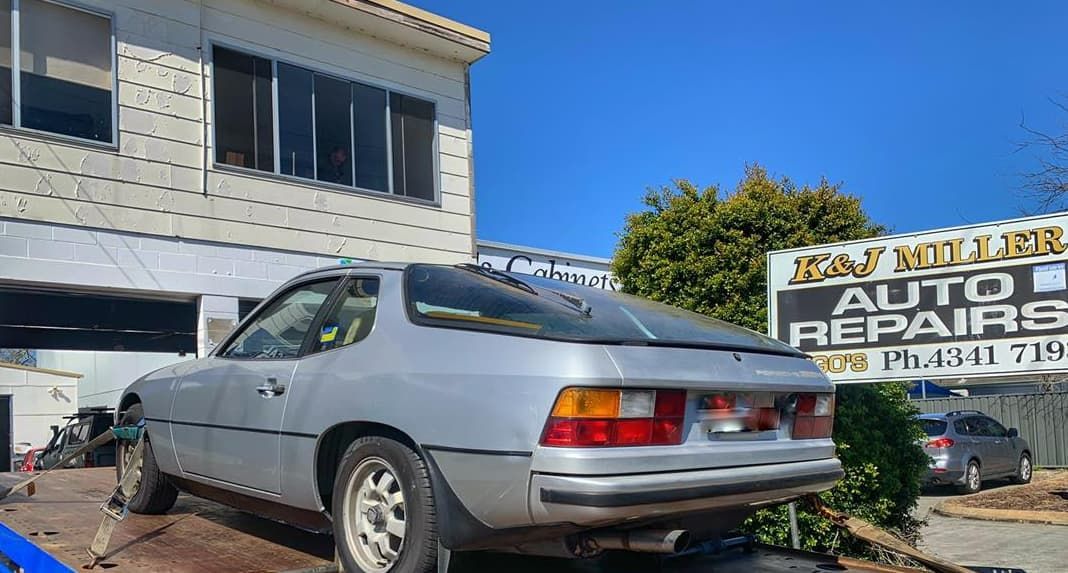 A Silver Car Is Parked In Front Of A Building — Coastwide Towing & Transport In Singleton, NSW